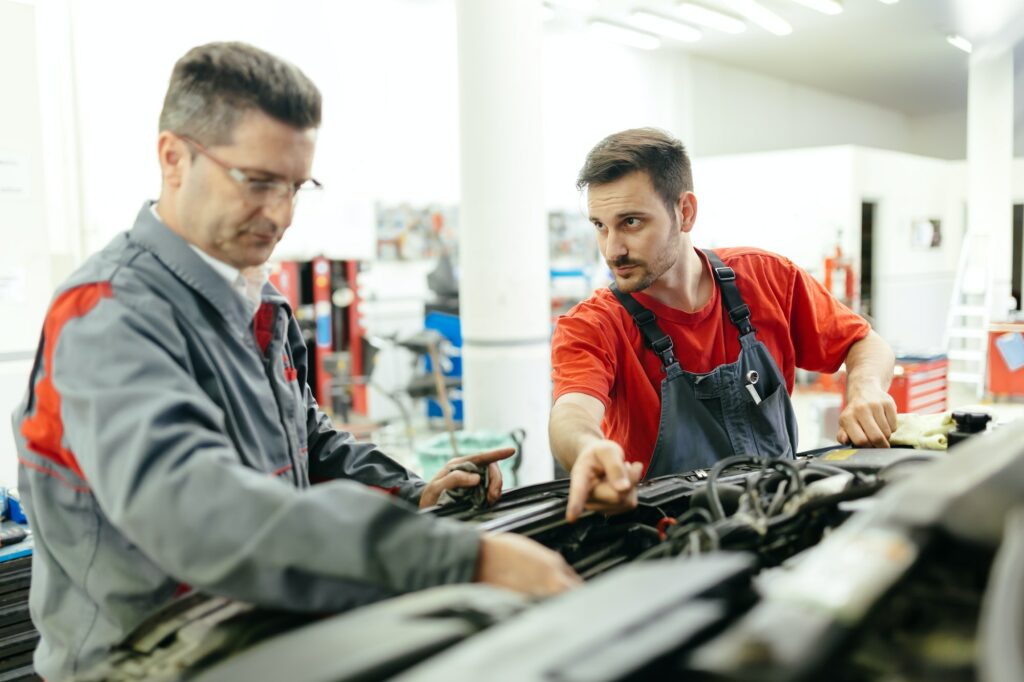 Car mechanics fixing car